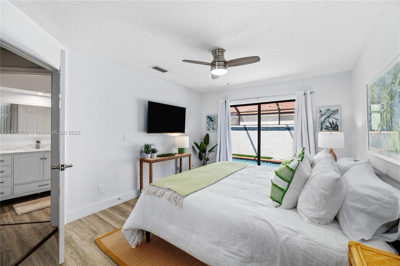 701 Sea Oats Drive, Unit D1 Juno Beach, FL 33408 - Photo 24 of 27 a bedroom with a bed and a flat screen tv