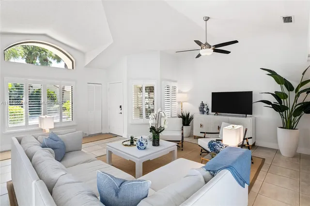 a living room with furniture a window and a flat screen tv