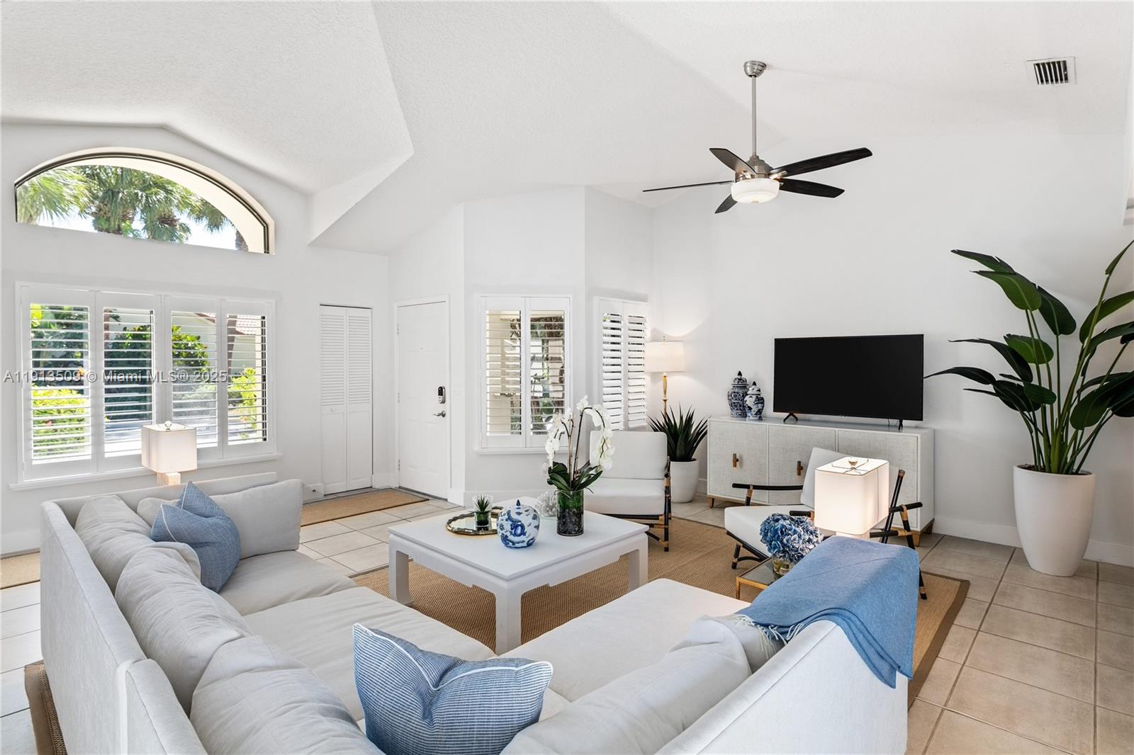 701 Sea Oats Drive, Unit D1 Juno Beach, FL 33408 - Photo 3 of 27 a living room with furniture a window and a flat screen tv