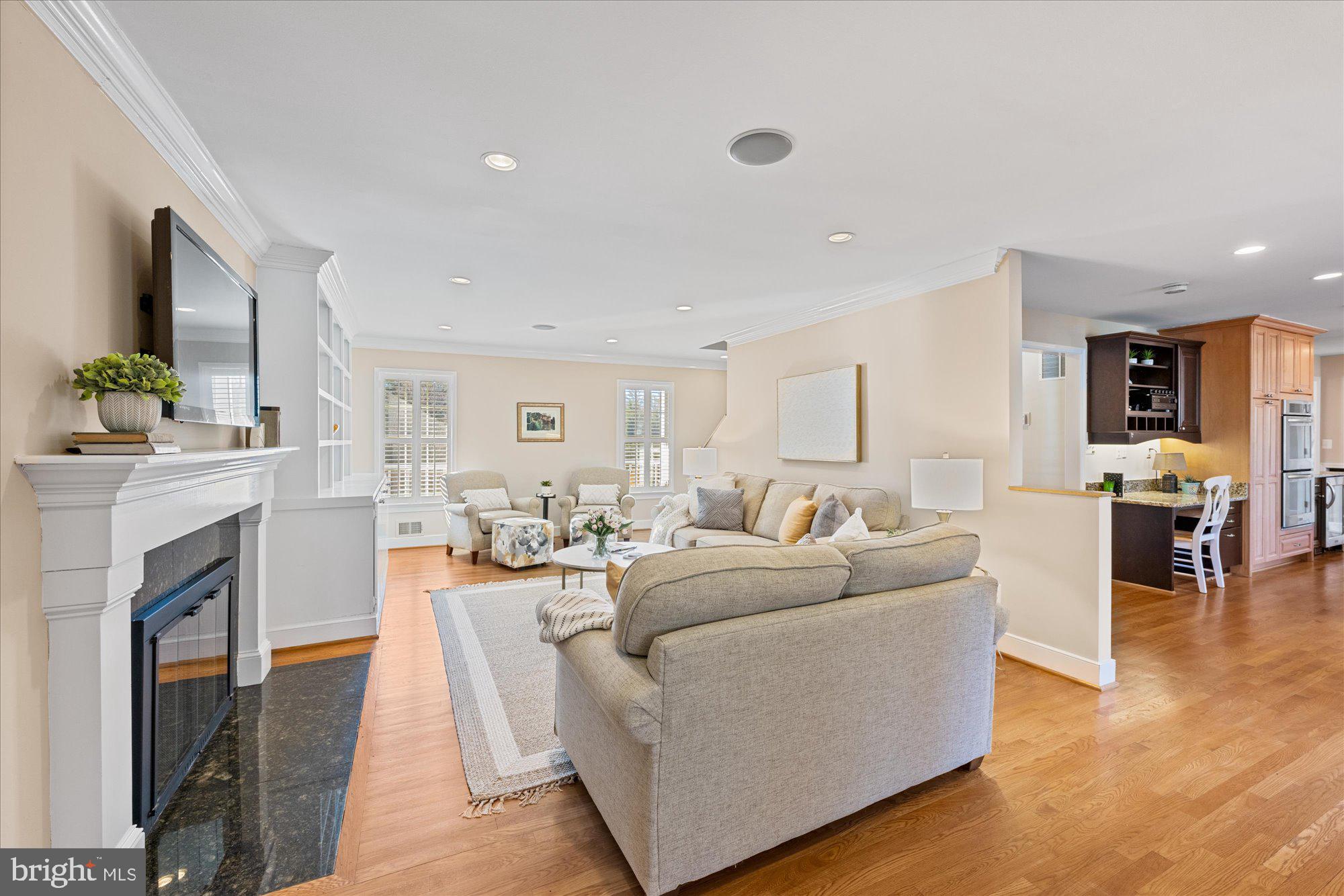 13321 Glen Mill Road Rockville, MD 20850 - Photo 11 of 31 a living room with furniture a fireplace and a flat screen tv