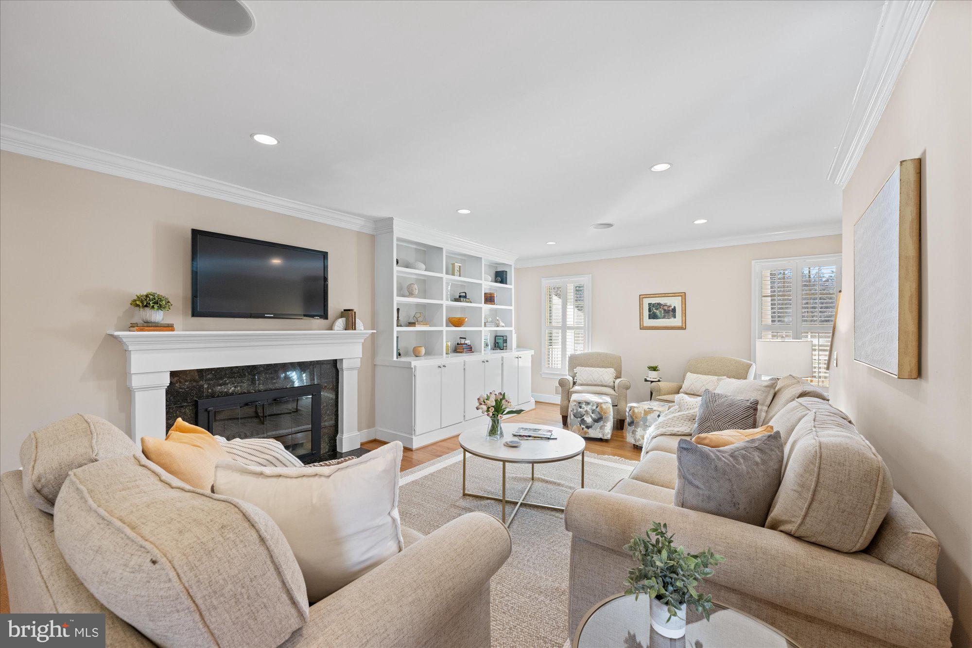 13321 Glen Mill Road Rockville, MD 20850 - Photo 12 of 31 a living room with furniture a fireplace and a flat screen tv