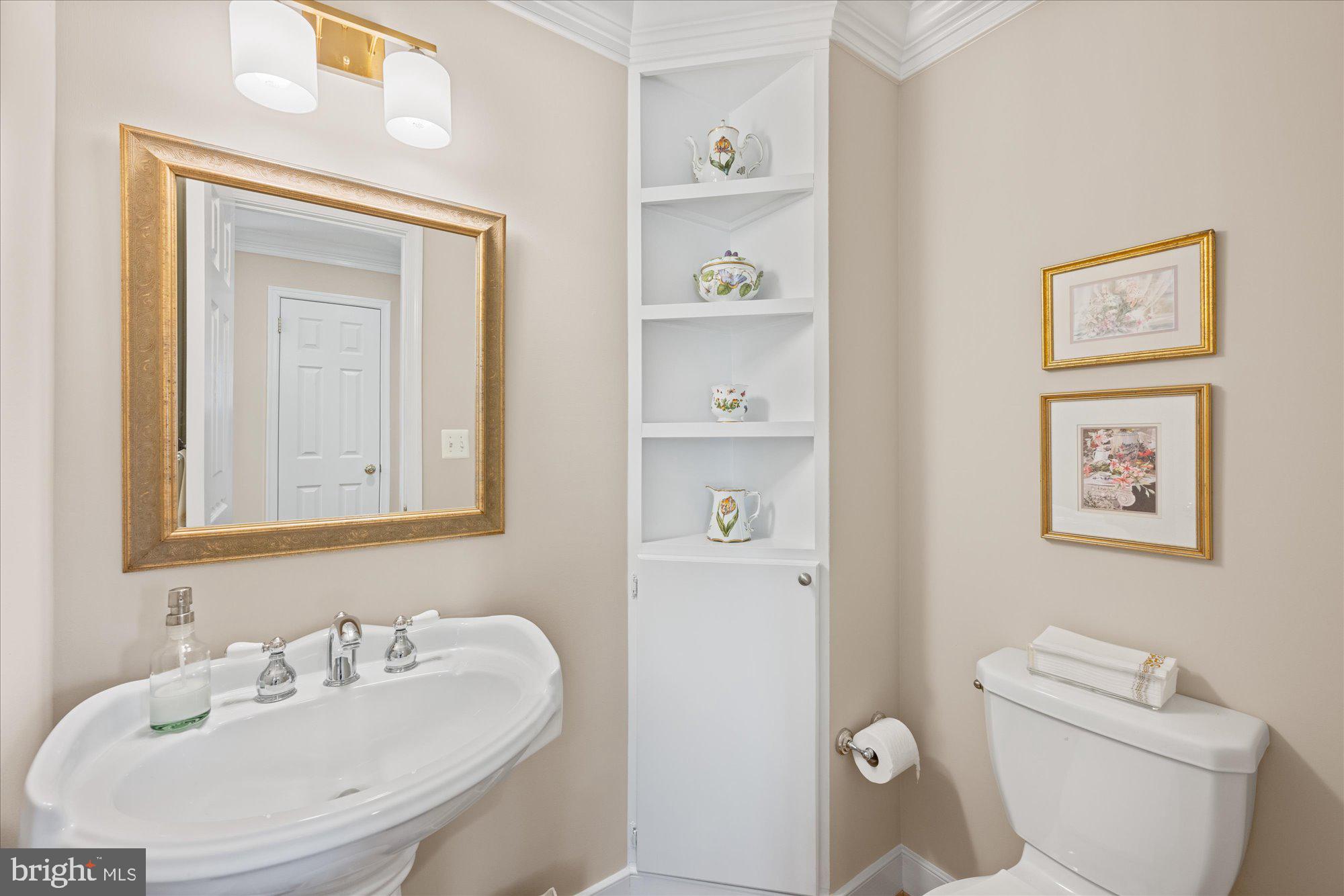 13321 Glen Mill Road Rockville, MD 20850 - Photo 15 of 31 a bathroom with a toilet sink and mirror