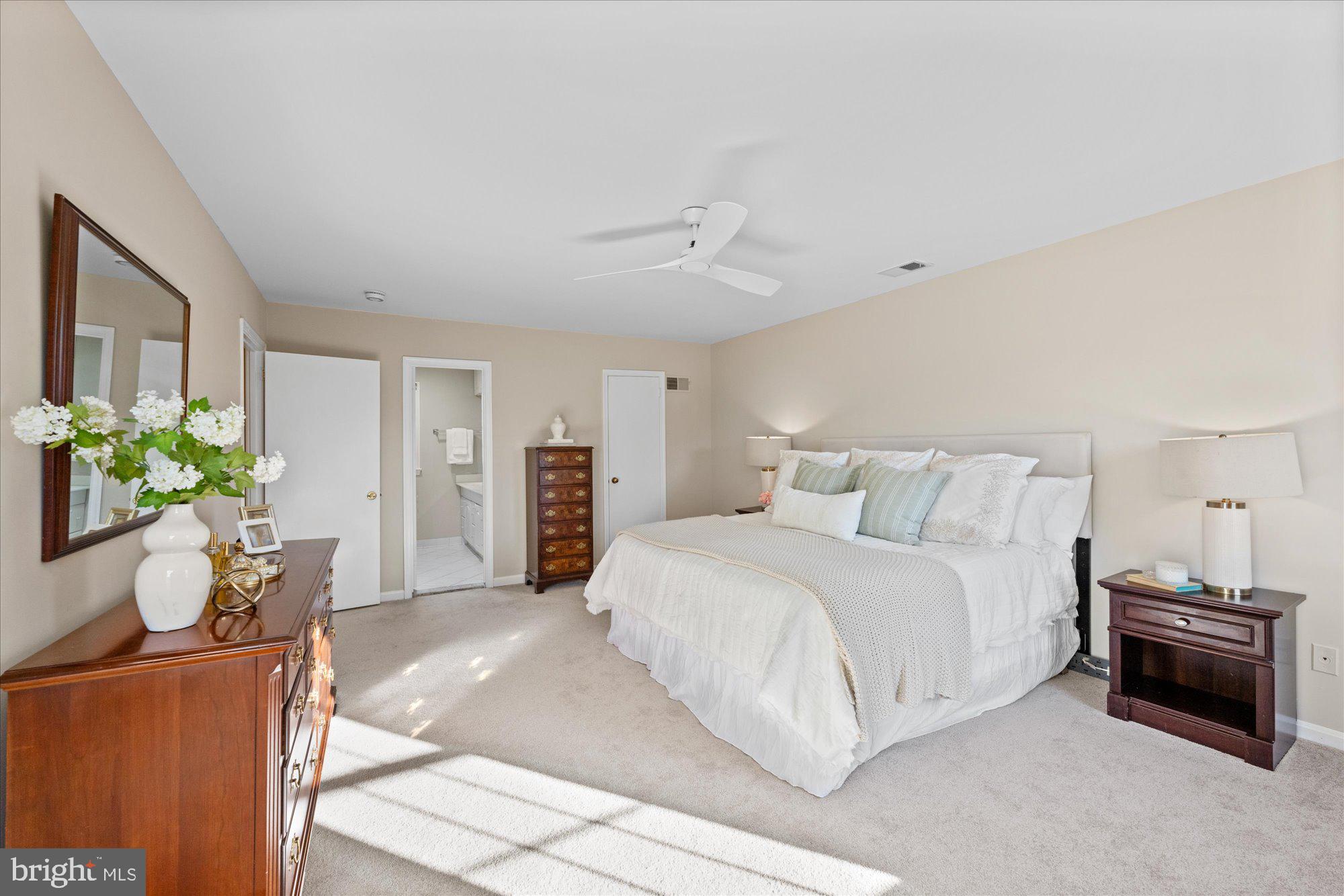 13321 Glen Mill Road Rockville, MD 20850 - Photo 17 of 31 a spacious bedroom with a bed and a potted plant