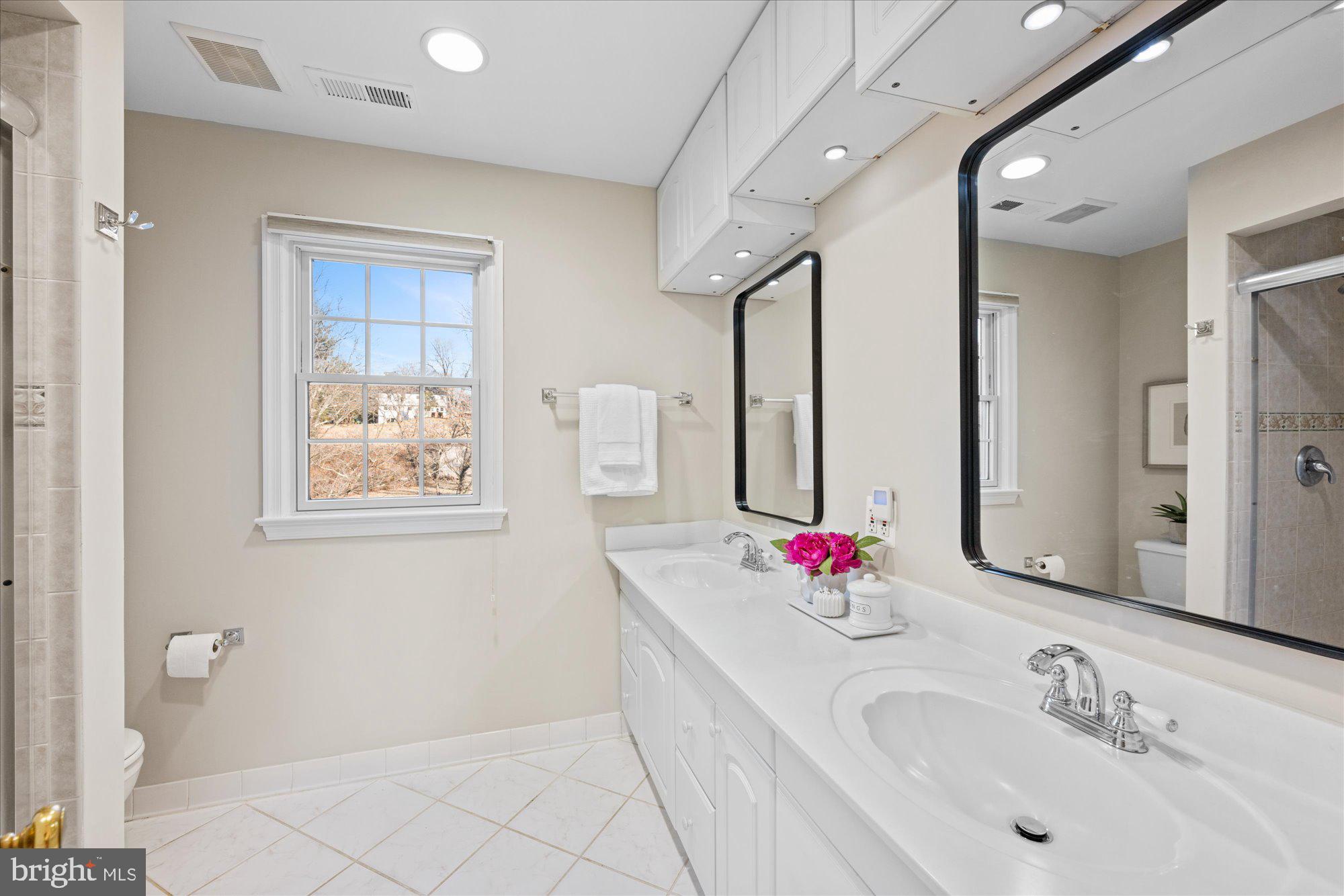 13321 Glen Mill Road Rockville, MD 20850 - Photo 18 of 31 a bathroom with a tub sink mirror and vanity