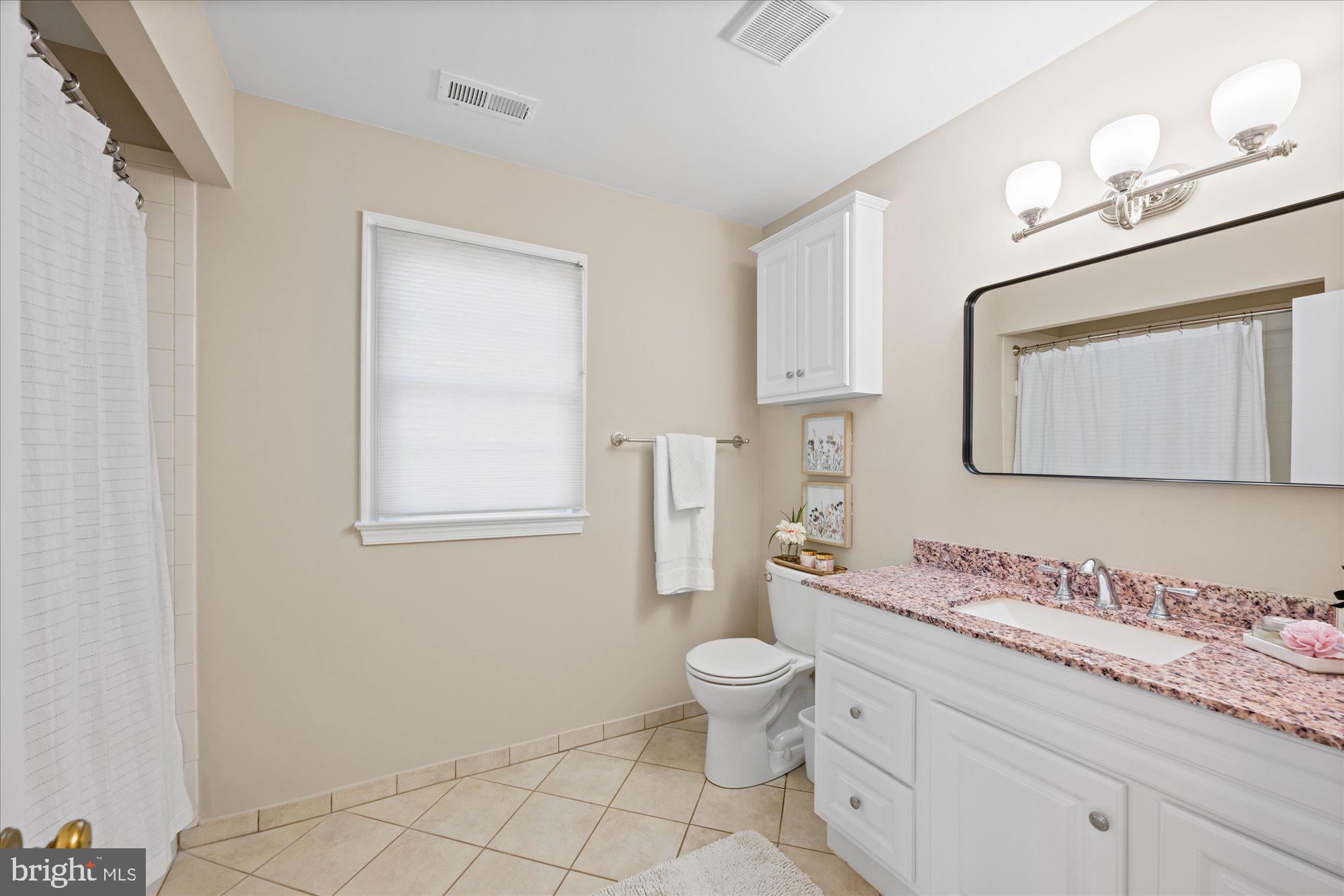 13321 Glen Mill Road Rockville, MD 20850 - Photo 22 of 31 a bathroom with a granite countertop toilet sink and mirror
