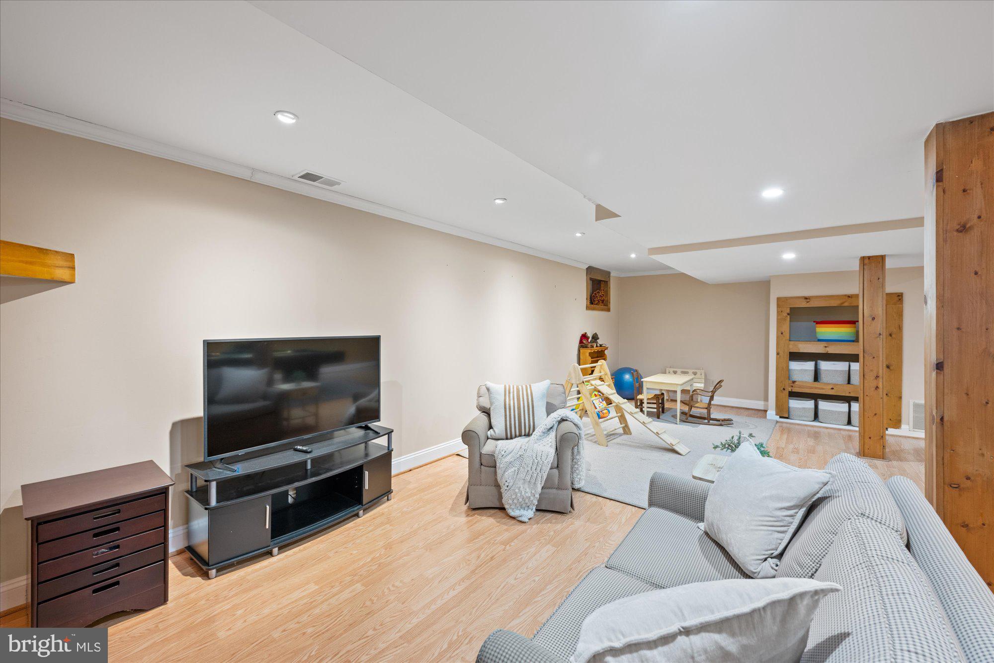 13321 Glen Mill Road Rockville, MD 20850 - Photo 27 of 31 a living room with furniture and a flat screen tv