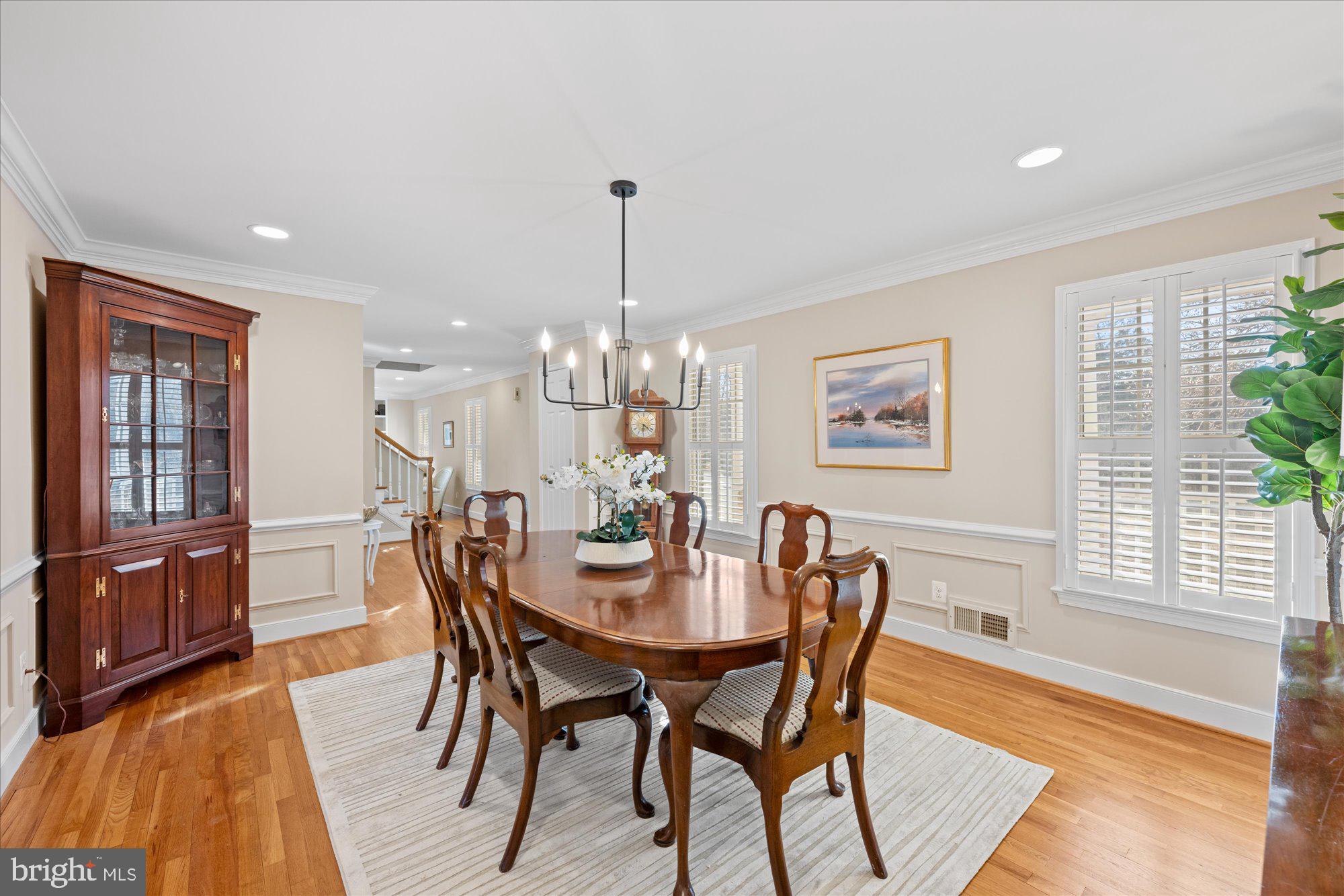 13321 Glen Mill Road Rockville, MD 20850 - Photo 5 of 31 a dining room with furniture a chandelier and wooden floor