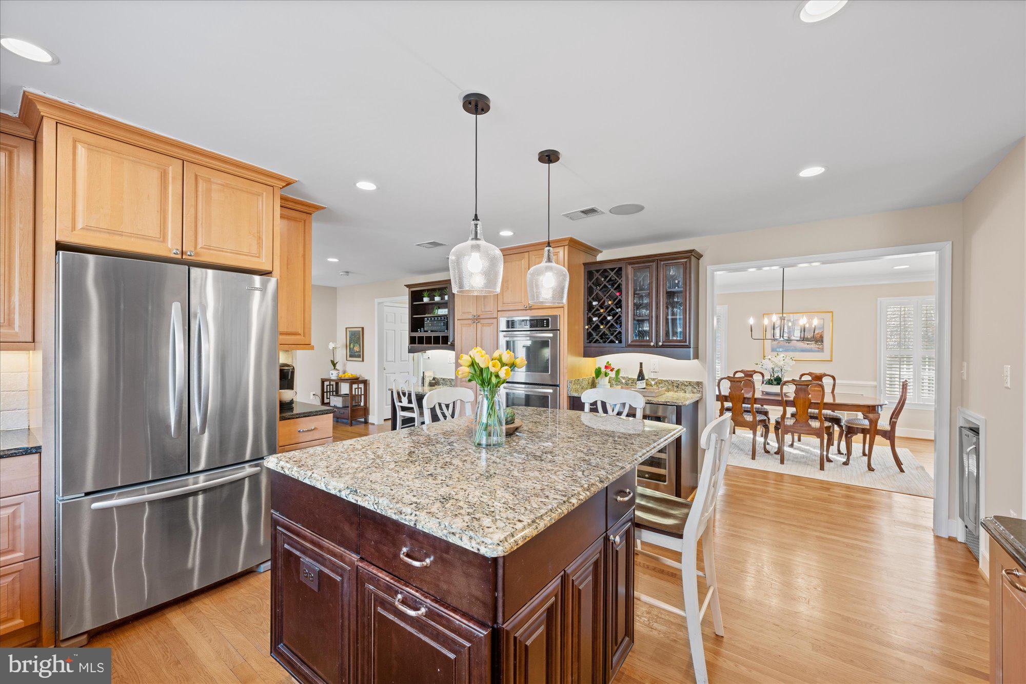 13321 Glen Mill Road Rockville, MD 20850 - Photo 9 of 31 a kitchen with stainless steel appliances granite countertop a table chairs and a refrigerator