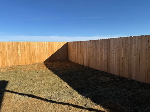 a view of an empty room and wooden floor