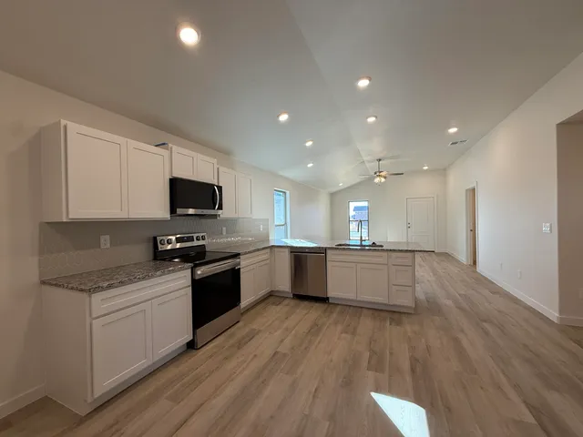 a kitchen with a sink stainless steel appliances and cabinets