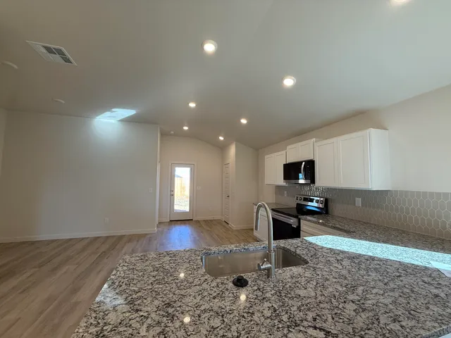 a kitchen with a refrigerator and a sink