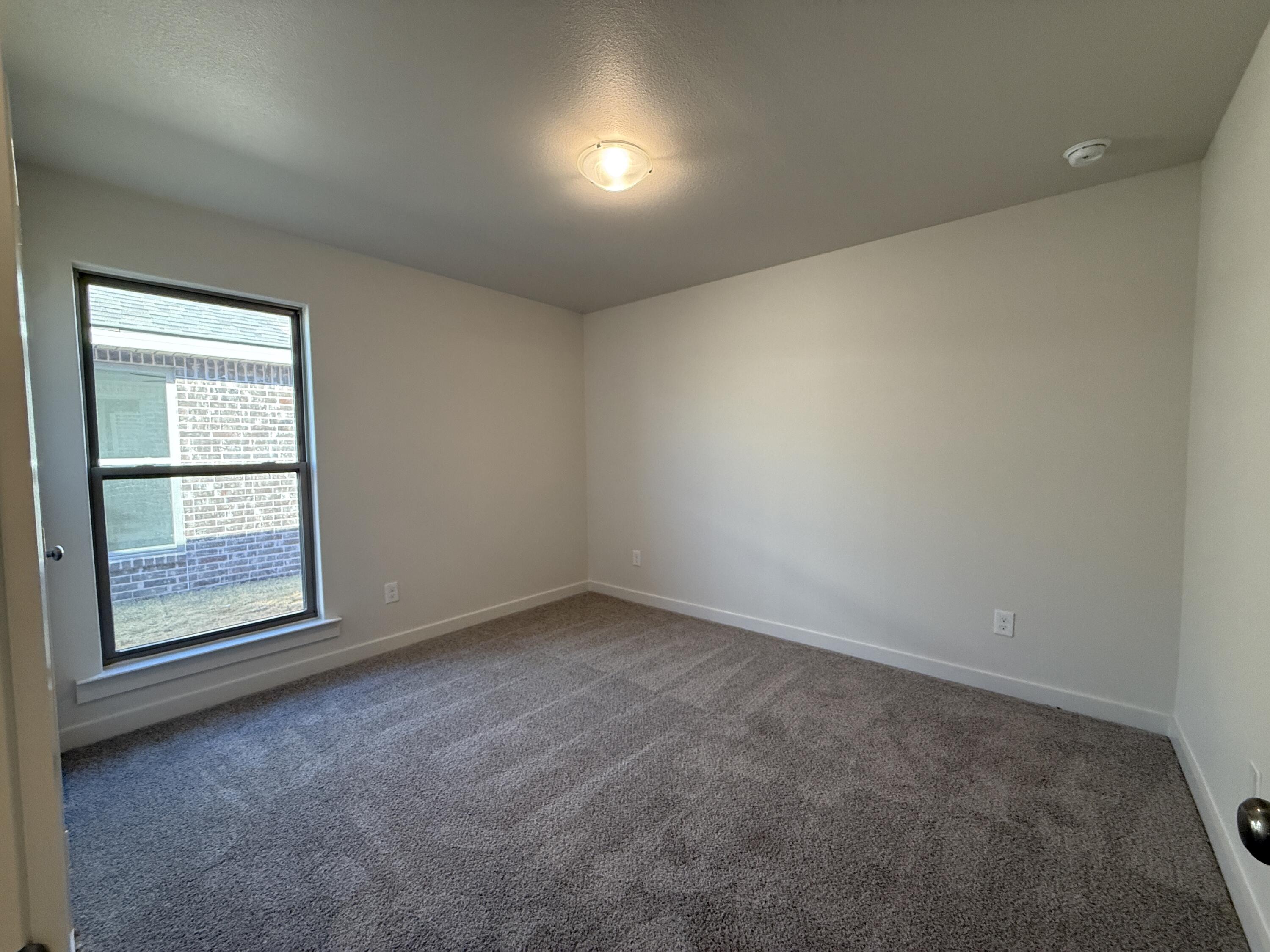 3104 138th Place Lubbock, TX 79423 - Photo 8 of 11 an empty room with a window