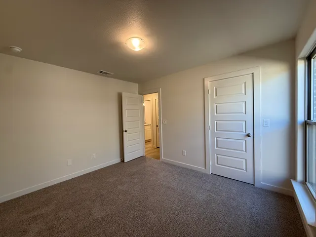 a view of an empty room and closet area