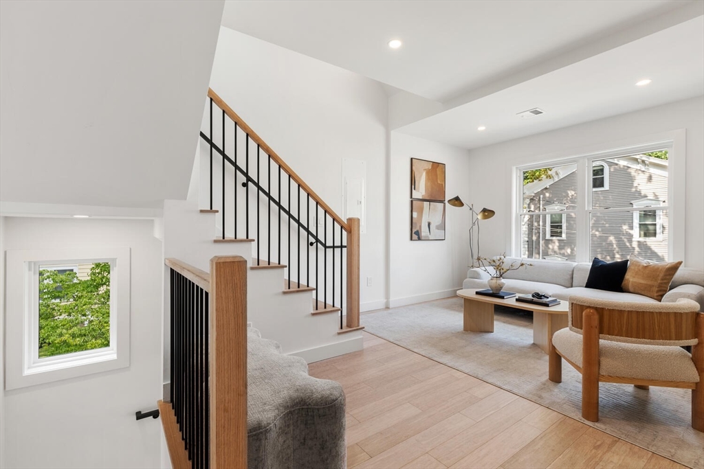 6 Wyman Court, Unit 6 Winchester, MA 01890 - Photo 11 of 35 a living room with furniture and a large window