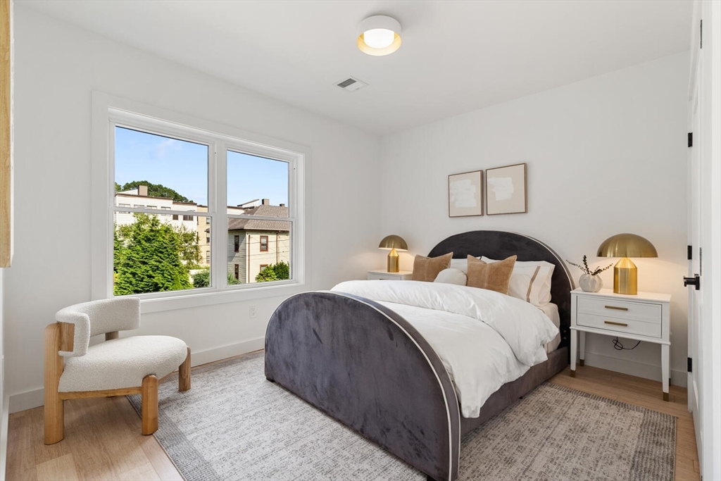 6 Wyman Court, Unit 6 Winchester, MA 01890 - Photo 13 of 35 a bed room with a bed and a couch