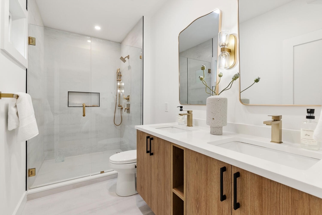 6 Wyman Court, Unit 6 Winchester, MA 01890 - Photo 17 of 35 a bathroom with a sink a toilet and shower