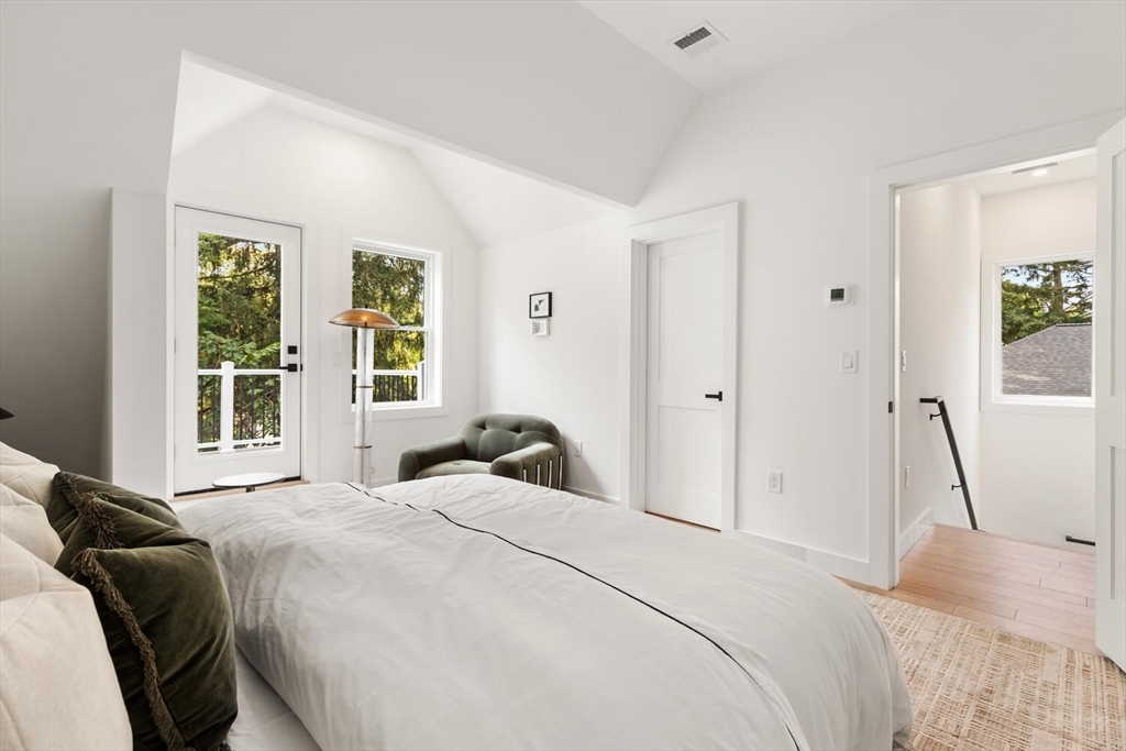 6 Wyman Court, Unit 6 Winchester, MA 01890 - Photo 19 of 35 a bedroom with a bed and a large window