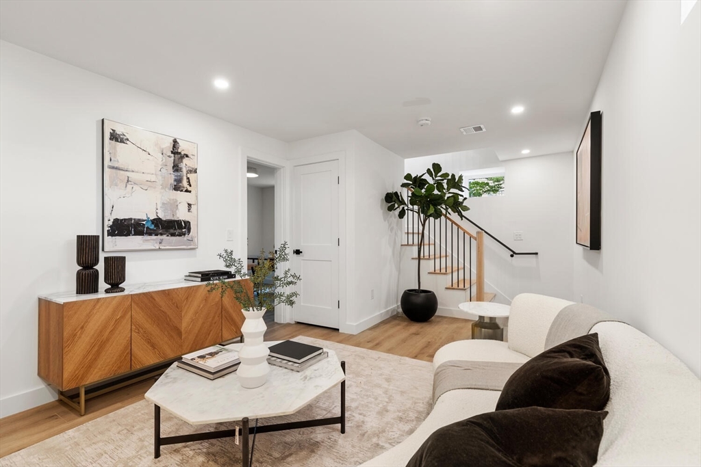 6 Wyman Court, Unit 6 Winchester, MA 01890 - Photo 22 of 35 a living room with furniture a plant and a potted plant