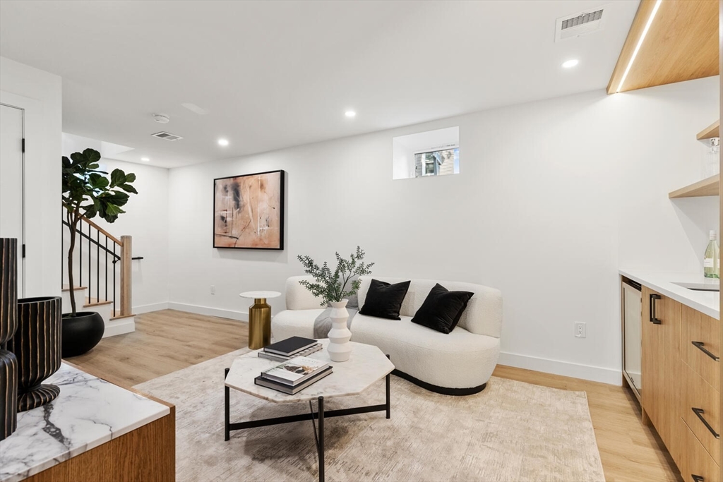 6 Wyman Court, Unit 6 Winchester, MA 01890 - Photo 23 of 35 a living room with furniture potted plant and a lamp