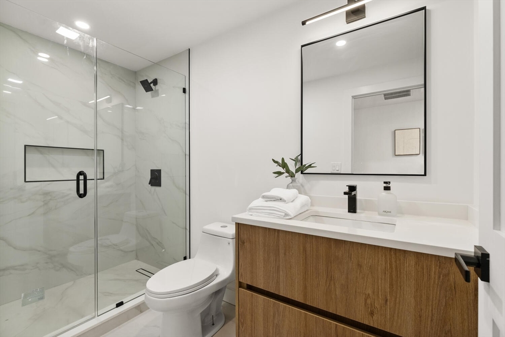 6 Wyman Court, Unit 6 Winchester, MA 01890 - Photo 25 of 35 a bathroom with a sink toilet and shower
