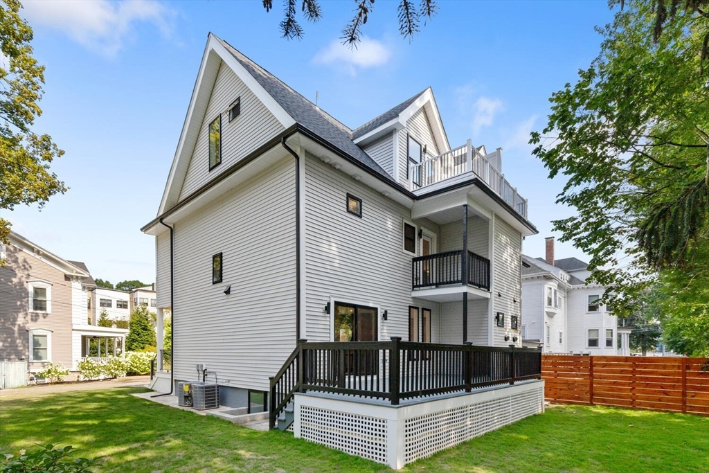 6 Wyman Court, Unit 6 Winchester, MA 01890 - Photo 27 of 35 a front view of a house with a yard