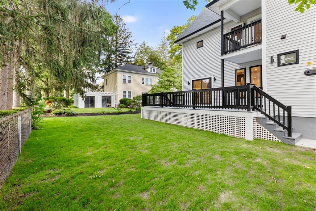 6 Wyman Court, Unit 6 Winchester, MA 01890 - Photo 28 of 35 a view of a house with a yard and sitting area