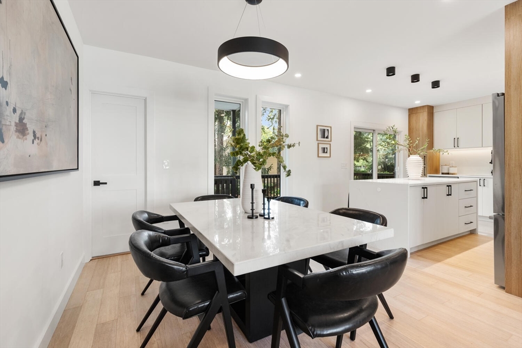 6 Wyman Court, Unit 6 Winchester, MA 01890 - Photo 4 of 35 a view of a dining room with furniture and wooden floor