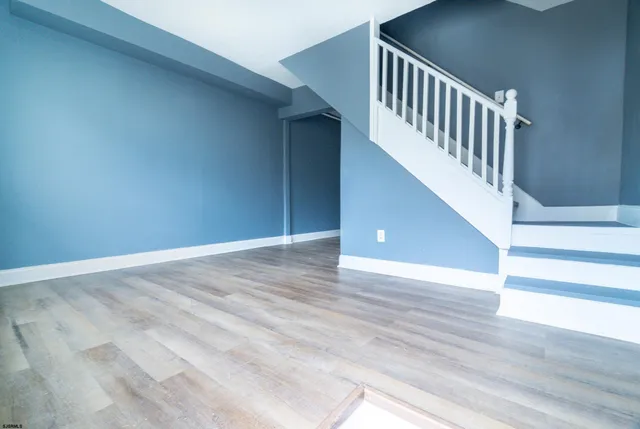 a view of an entryway with wooden floor