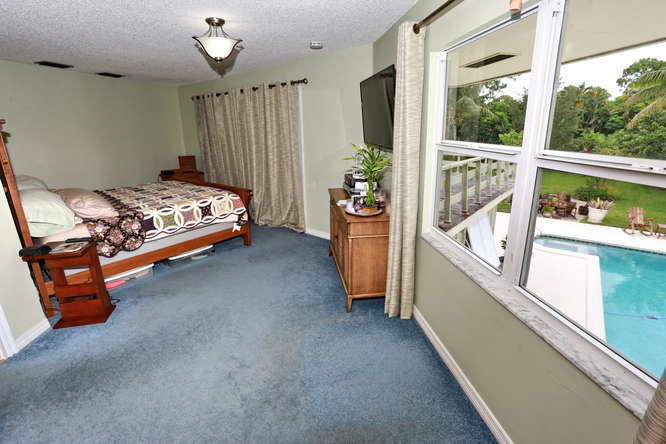 5605 2nd Road Lake Worth, FL 33467 - Photo 12 of 30 a bed room with furniture and a window