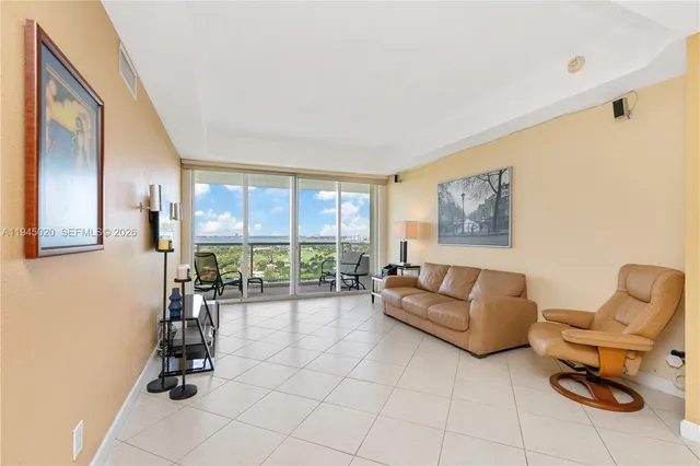 a living room with furniture and large windows