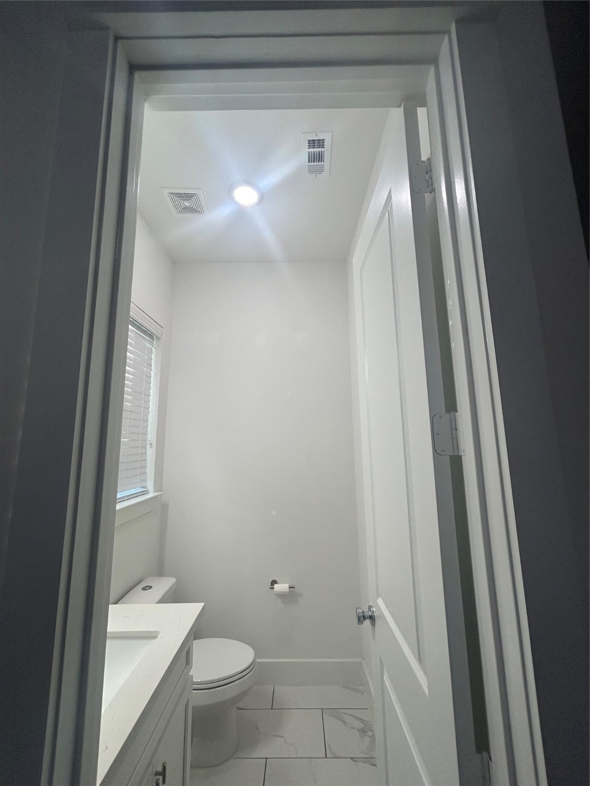 4605 Lavatera Street Houston, TX 77018 - Photo 13 of 50 a bathroom with a granite countertop toilet and a sink
