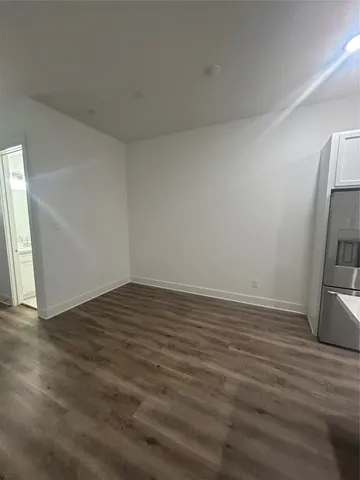a view of a room with wooden floor and a sink