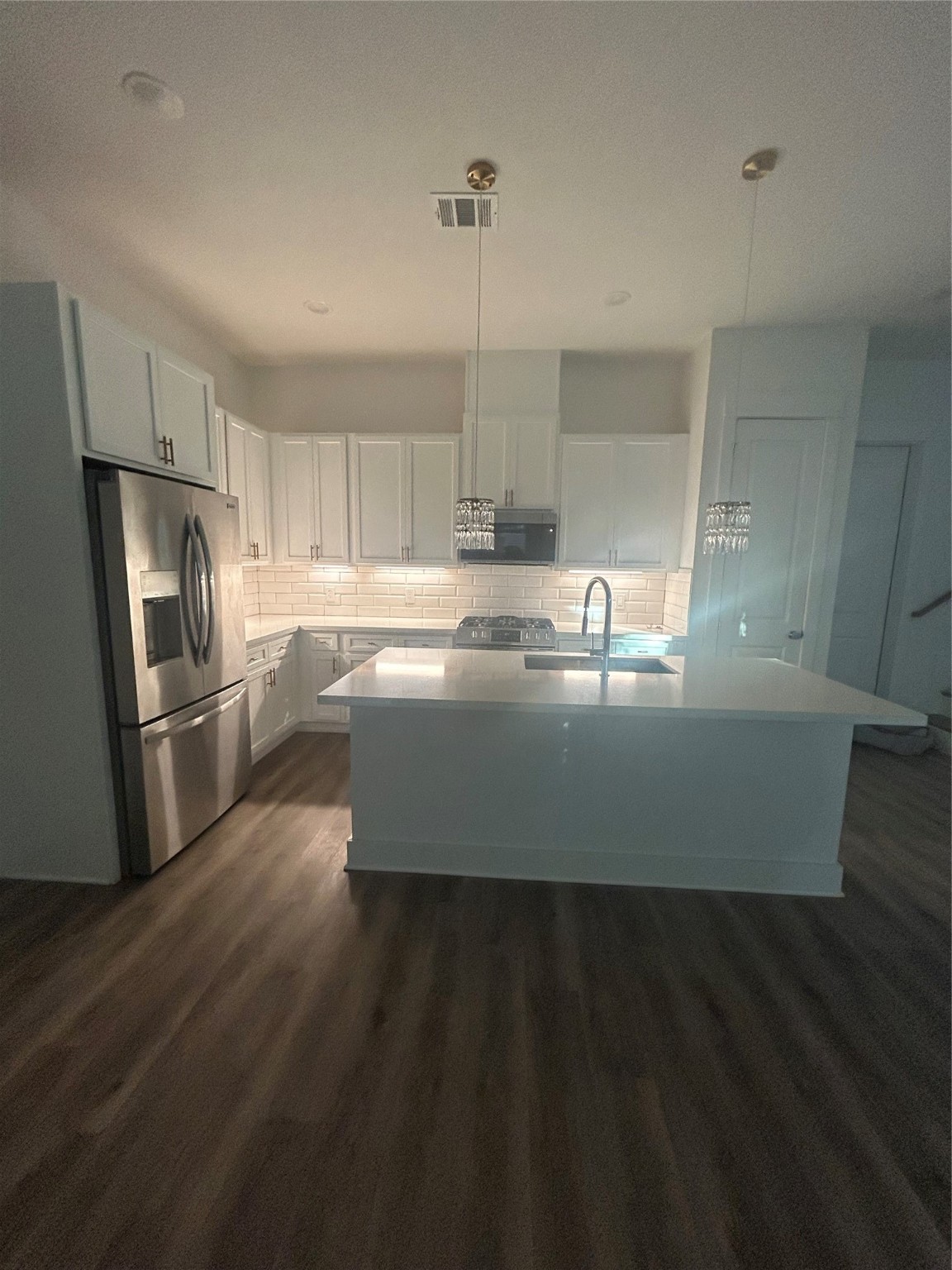 4605 Lavatera Street Houston, TX 77018 - Photo 18 of 50 a kitchen with kitchen island a sink dishwasher a refrigerator and wooden floor