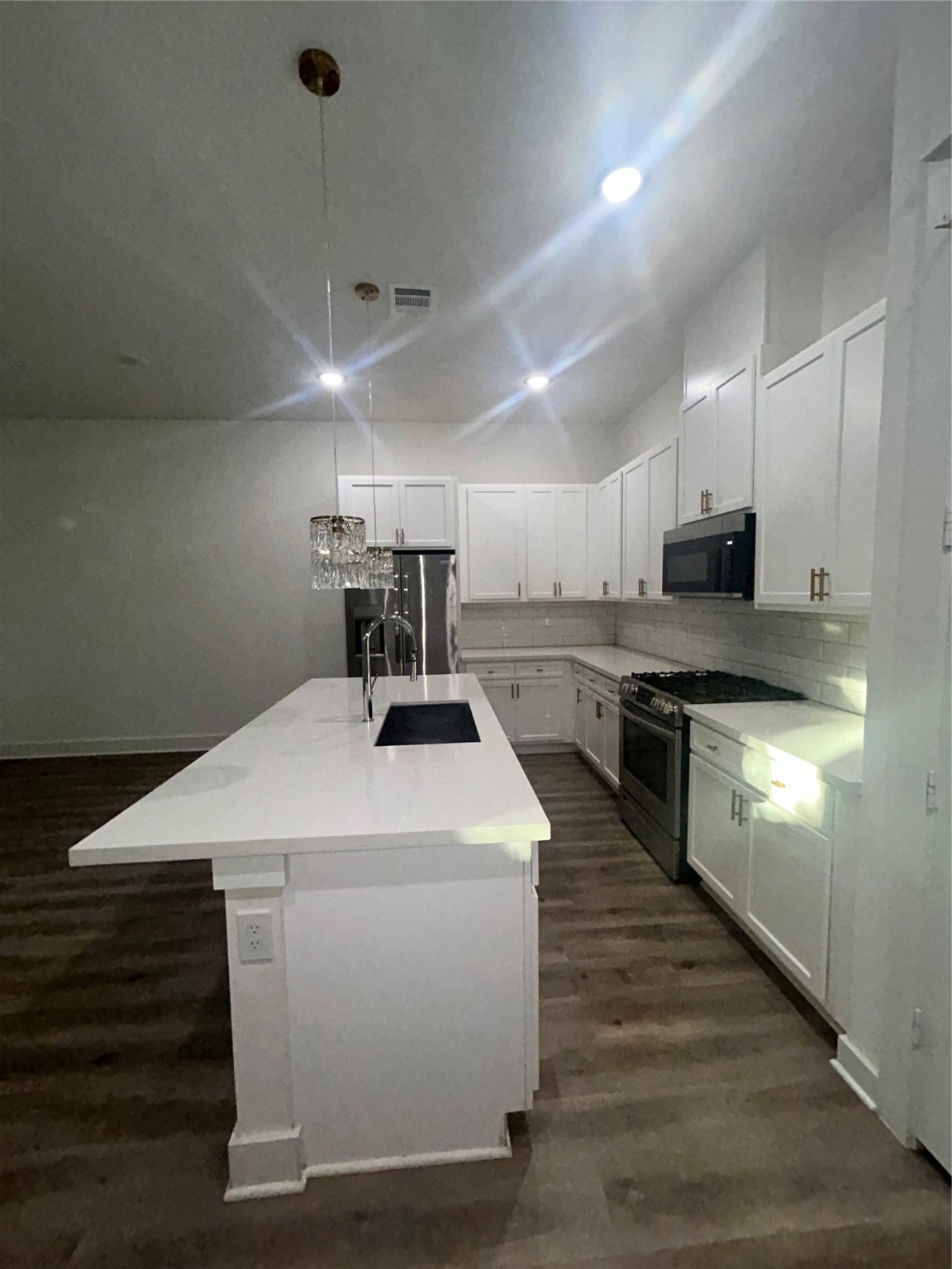 4605 Lavatera Street Houston, TX 77018 - Photo 22 of 50 a kitchen with a stove a sink and a refrigerator