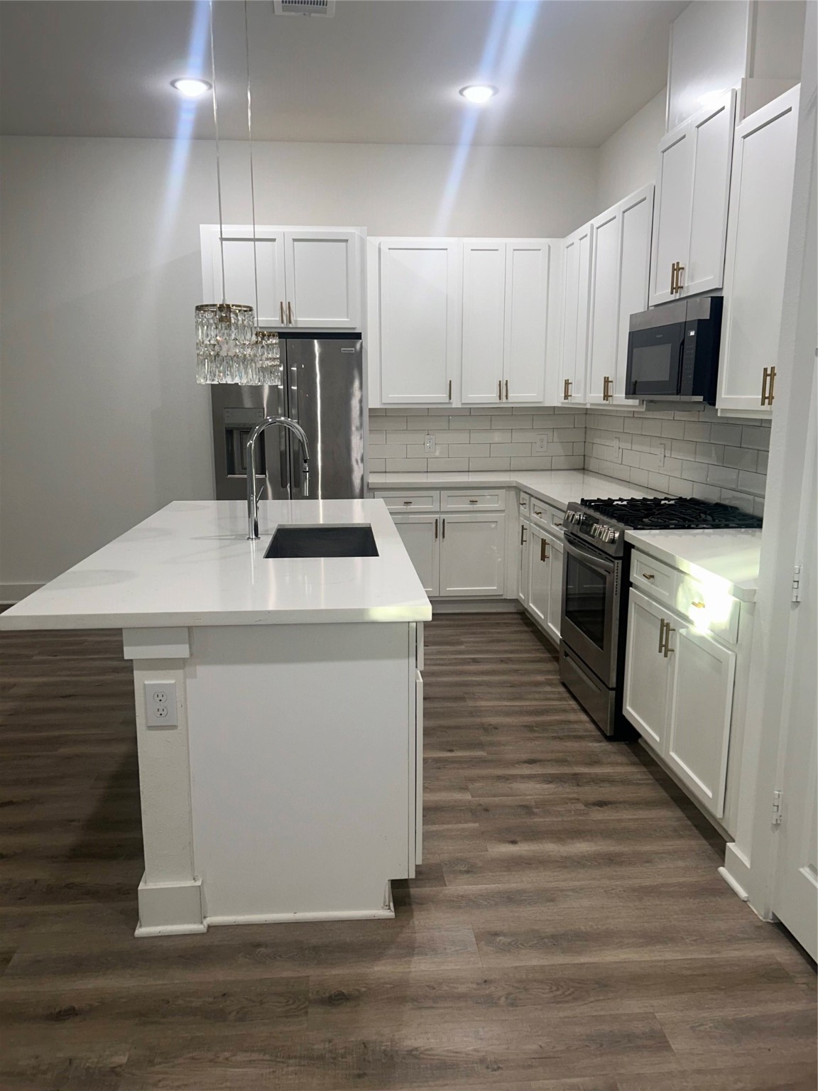 4605 Lavatera Street Houston, TX 77018 - Photo 30 of 50 a kitchen with stainless steel appliances kitchen island granite countertop a stove a sink and a microwave