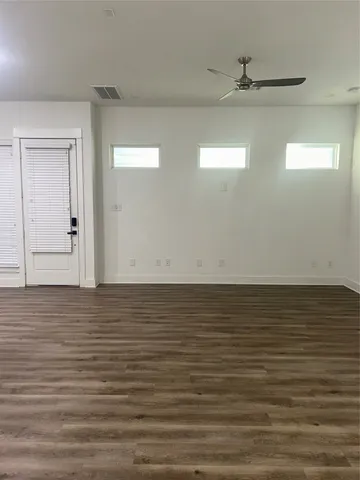 a large kitchen with kitchen island white cabinets and stainless steel appliances