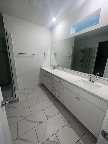 a bathroom with a shower and a sink