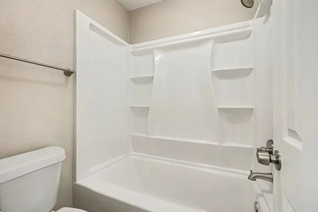 a white bath tub with a shower
