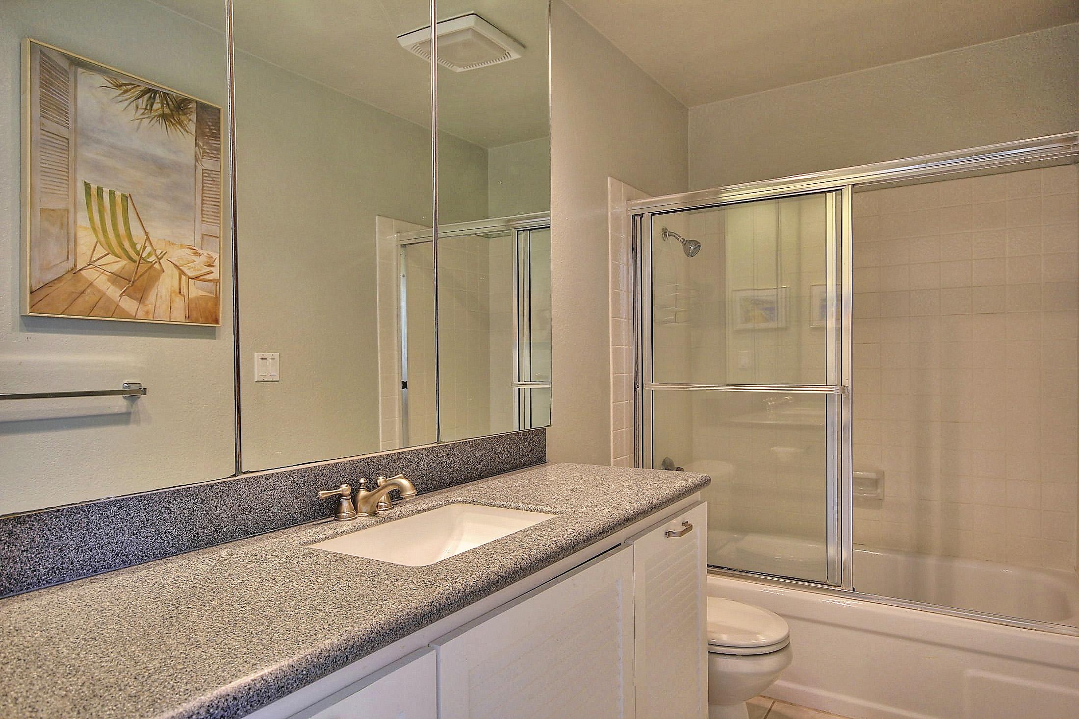 3375 Foothill Road, Unit 532 Carpinteria, CA 93013 - Photo 7 of 13 a bathroom with a granite countertop sink toilet and shower