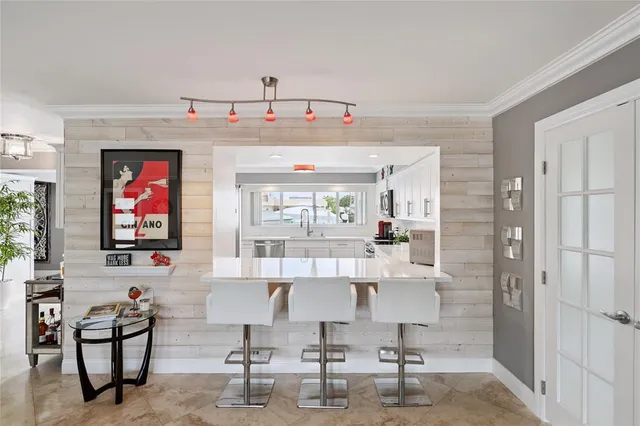 a living room with furniture and large windows