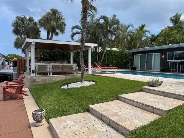 a view of a house with a backyard porch and sitting area