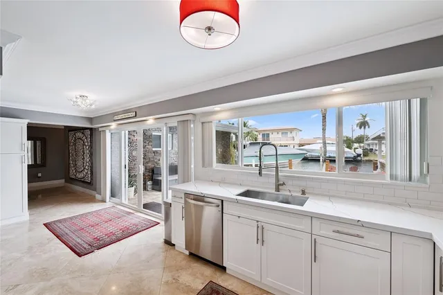 a kitchen with a dining table chairs and white cabinets