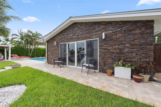 a aerial view of a house with swimming pool and porch