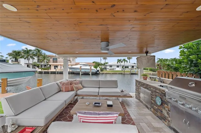 an aerial view of a house with swimming pool a patio and lake view