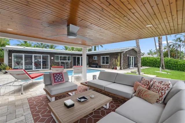 a view of swimming pool with outdoor seating and a garden