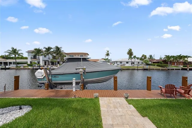 a view of a swimming pool with a lawn chairs and a barbeque