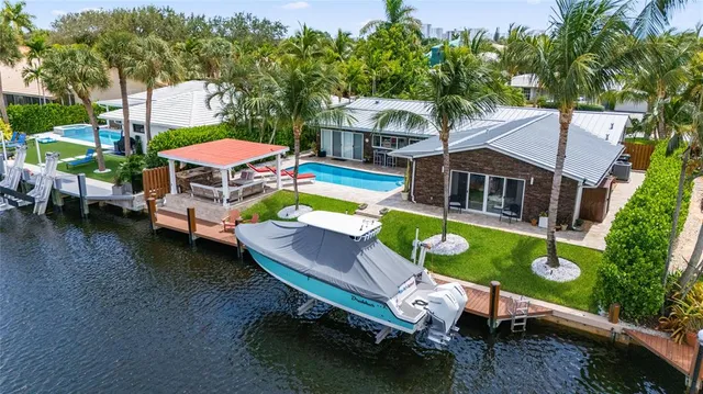 a front view of a house with palm trees