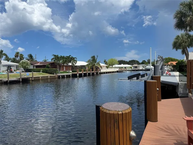 an aerial view of a house with a yard and sitting area