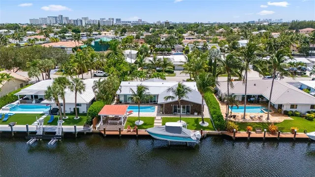 an aerial view of lake and residential houses with outdoor space