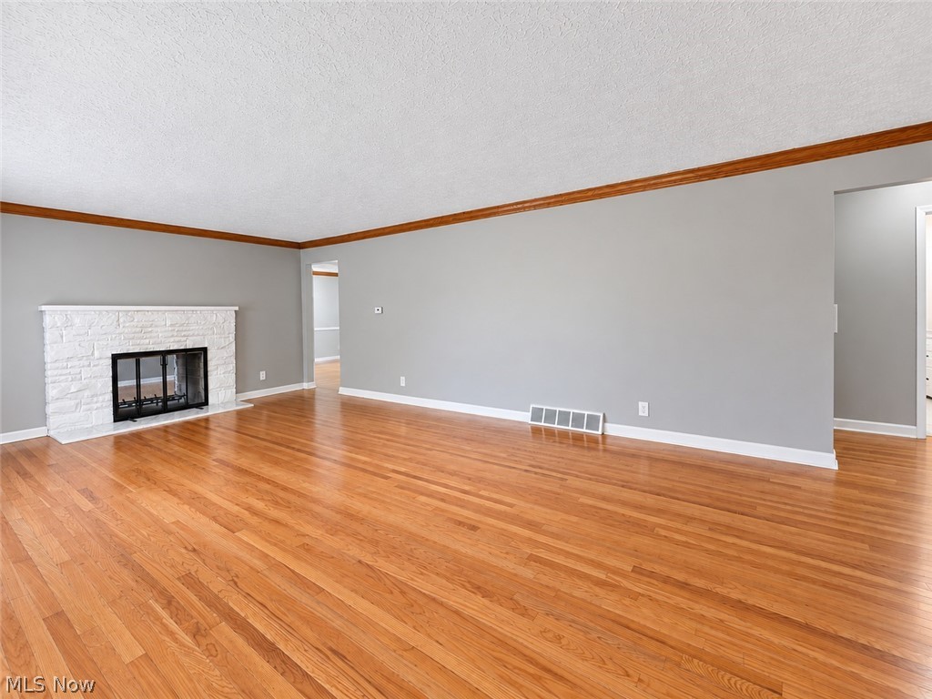 2961 Chamberlain Road Akron, OH 44333 - Photo 3 of 18 Living room with hardwood floors and wood burning 2 sided fireplace